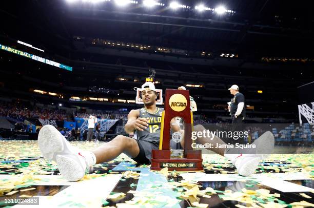 Jared Butler of the Baylor Bears sits on the court with the trophy after defeating the Gonzaga Bulldogs 86-70 in the National Championship game of...