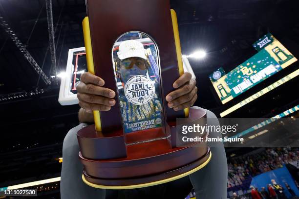 Davion Mitchell of the Baylor Bears holds the trophy after defeating the Gonzaga Bulldogs 86-70 in the National Championship game of the 2021 NCAA...