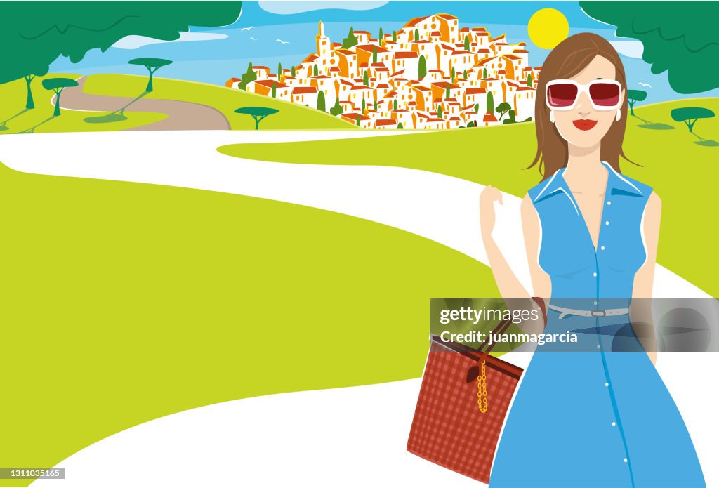 Elegant woman in summer dress walking in the field