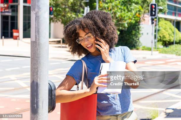 african-australian woman using elbow bump to activate crosswalk button - indigenous australia stock pictures, royalty-free photos & images
