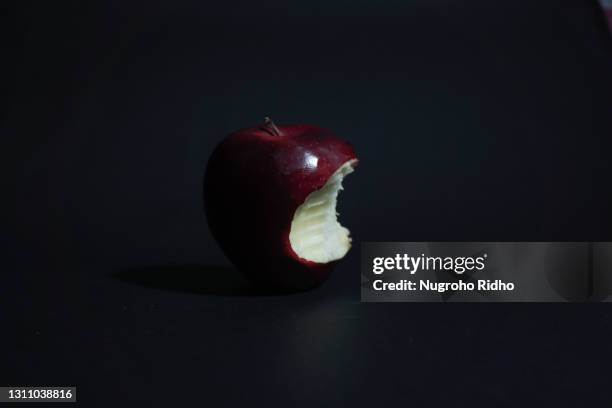 one bite of apple - red apples stock pictures, royalty-free photos & images