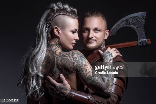 weapon wielding viking warrior couple in studio shot - viking stock pictures, royalty-free photos & images
