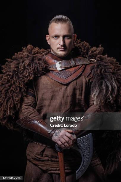 weapon wielding viking warrior in studio shot - viking warrior stock pictures, royalty-free photos & images