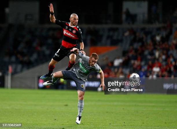 James Troisi of the Wanderers competes for the ball against Oliver Bozanic of the Mariners during the A-League match between Western Sydney Wanderers...