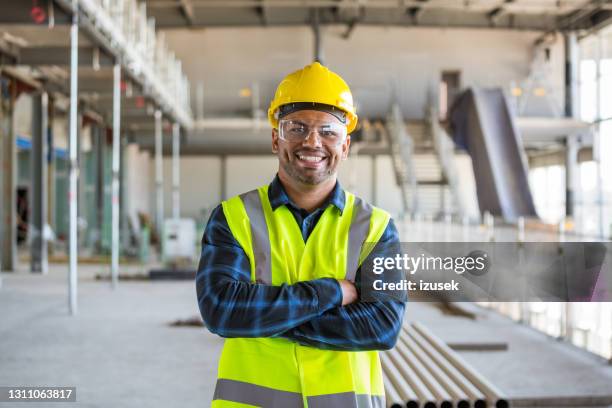 construction worker at an indoor construction site - construction worker pose stock pictures, royalty-free photos & images