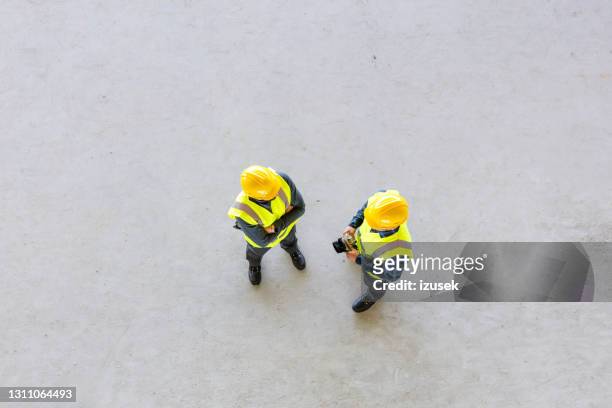 high angle view of construction workers - safety vest stock pictures, royalty-free photos & images
