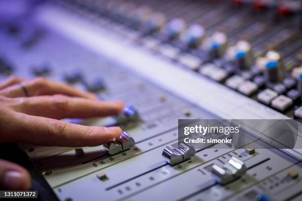 human hand adjusting buttons on audio mixer - equalizer stock pictures, royalty-free photos & images