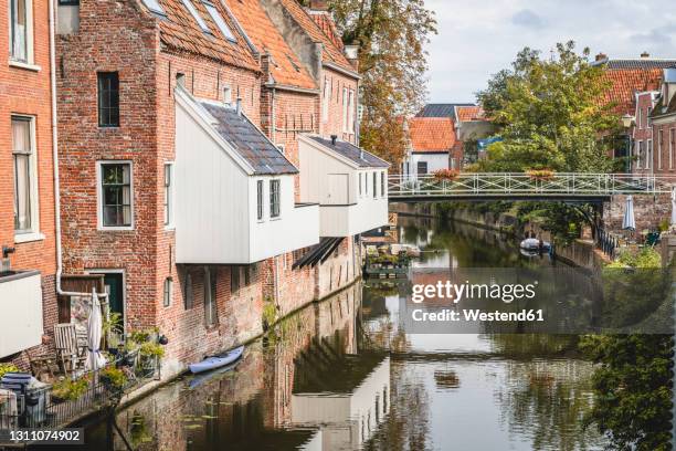 netherlands, groningen province, appingedam, hanging kitchens over damsterdiep canal - groningen city stock-fotos und bilder