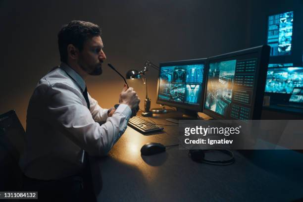 professional security support specialists and system security working on computers in monitoring control room with digital screens with server data, blockchain network and surveillance maps. - security guard stock pictures, royalty-free photos & images