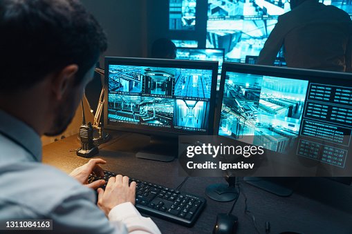 Security guard watching video monitoring surveillance security system. Security guard watching video monitoring surveillance security system.