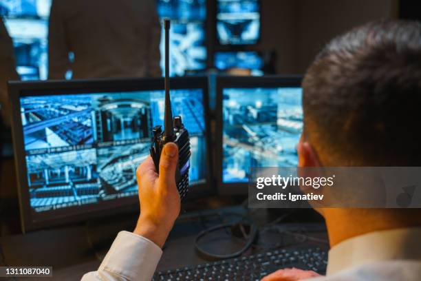 attention to all security posts. a security officer uses a professional walkie-talkie to warn about possible violations of the border of the protected object. - finland police stock pictures, royalty-free photos & images