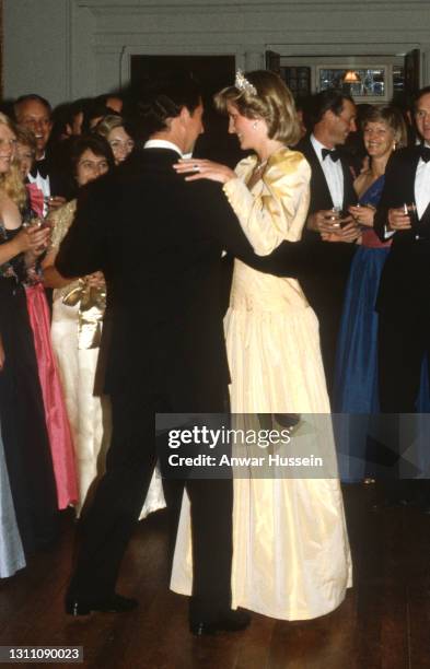 Prince Charles, Prince of Wales and Diana, Princess Of Wales, wearing a yellow satin ballgown designed by Murray Arbeid with the Queen Mary Cambridge...