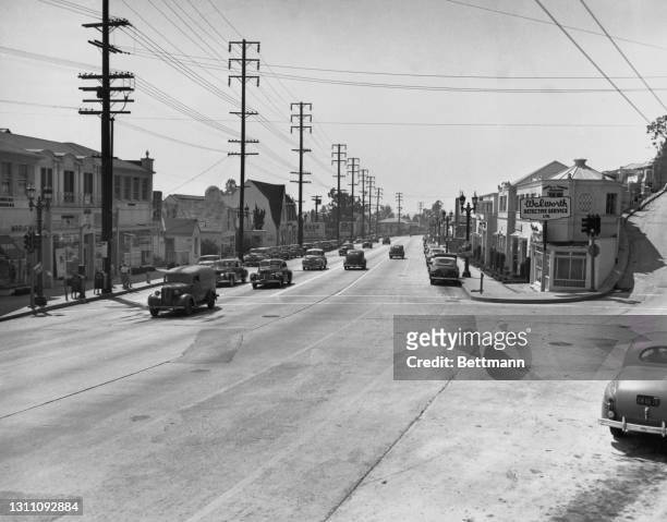 Cables suspended overhead from utility poles while below motorists make their way long Sunset Strip, a stretch of Sunset Boulevard that passes...