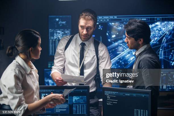 a team consisting of three special fbi officers investigates a mysterious case. - fbi special agent stock pictures, royalty-free photos & images