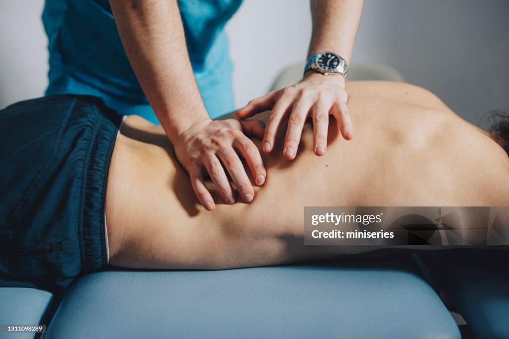 Close up of Physical Therapist Massaging Lower Back