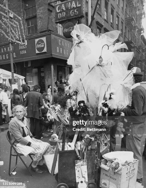 An elderly street vendor has a moment to herself during the Feast of San Gennaro, in the Little Italy district of the borough of Manhattan in New...