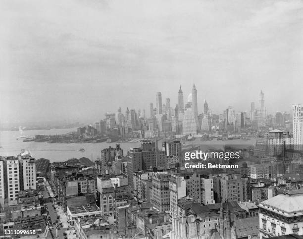 View across the East River towards Manhattan as seen from over the rooftops of the borough of Brooklyn, New York City, New York, 8th May 1936.