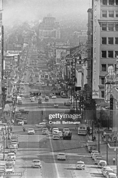 Pedestrians on the sidewalk and busy traffic on Hollywood and Vine, the intersection of Hollywood Boulevard and Vine Street, with the verticle...