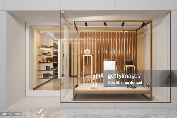 exterior of clothing store with shoes and other accessories displaying in showcase - retail store stock pictures, royalty-free photos & images