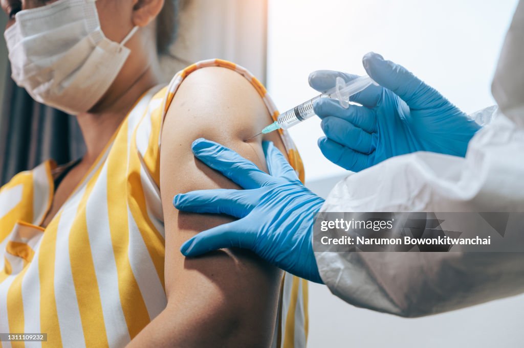 The doctor injecting the COVID-19 Vaccine for the woman
