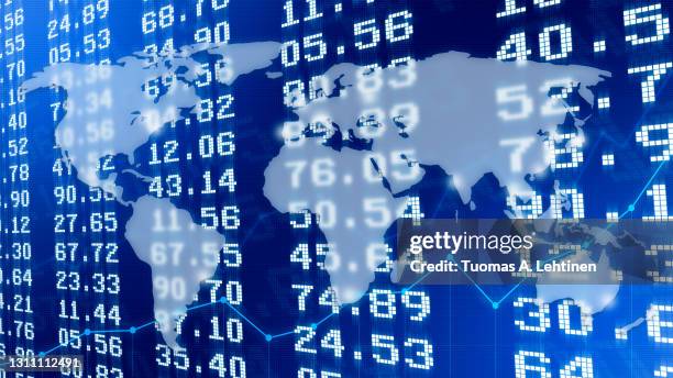 transparent world map over financial figures or exchange rates on stock exchange board and light blue line graphs. - 為替相場 ストックフォトと画像