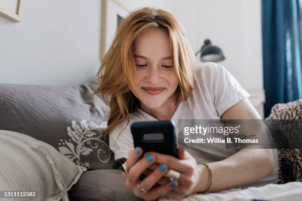 woman messaging using online dating app - anticipation expression stock pictures, royalty-free photos & images
