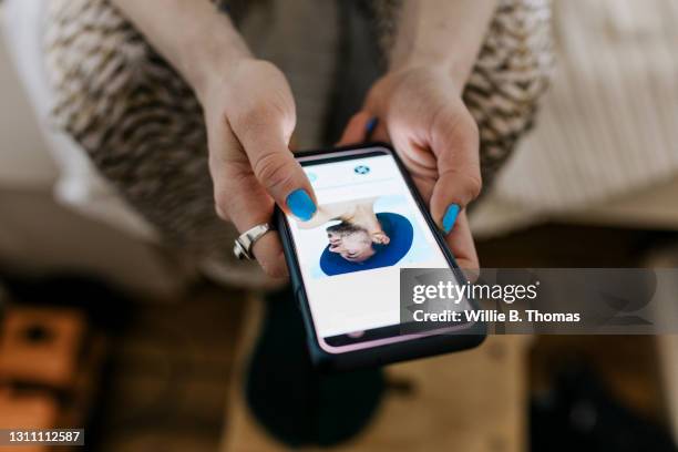 close up of woman looking at male profile on dating app - male cellphone stock-fotos und bilder