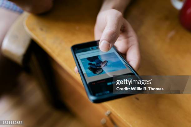 close up of man looking at profiles on dating app - lonely hearts stock pictures, royalty-free photos & images