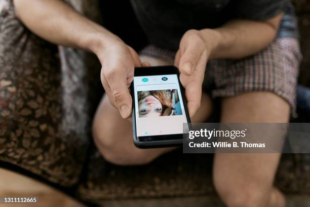 close up of man looking at woman's online dating profile - lonely hearts stock pictures, royalty-free photos & images