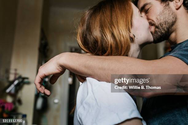 couple affectionately kissing each other - first girlfriend stock pictures, royalty-free photos & images