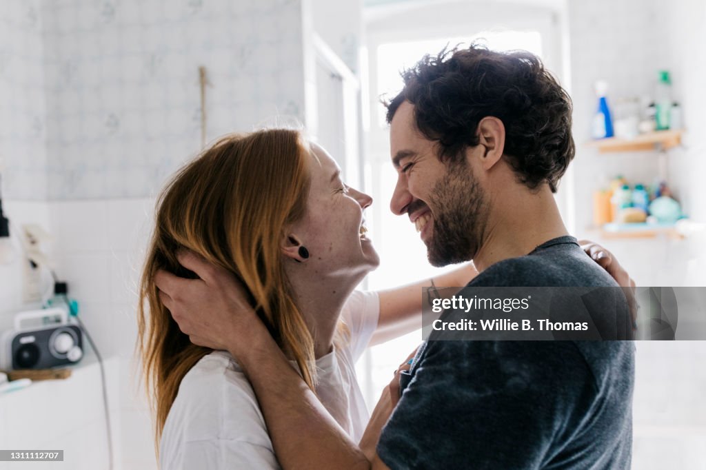 Couple Affectionately Embracing And Smiling Together