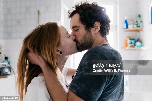 couple romantically engaged in a kiss - pecking stock-fotos und bilder