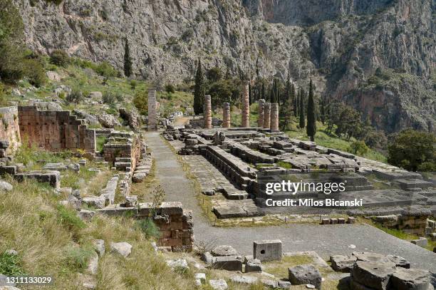 View on ancient ruins of The Doric columns of the Temple of Apollo in the Archaeological Site of Delphi , on April 4, 2021 in Delphi, Greece.The...