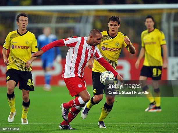 Sebastian Kehl of Dortmund is challenged by Rafik Djebbour of Olympiacos during the UEFA Champions League group F match between Borussia Dortmund and...