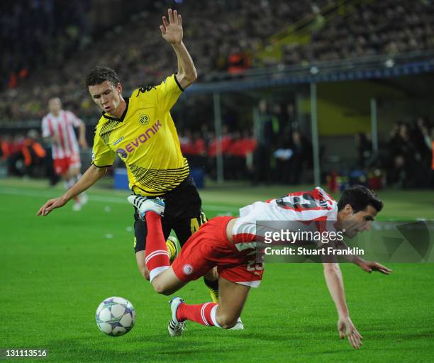 Ivan Perisic of Dortmund is challenged by Ivan Marcano of Olympiacos during the UEFA Champions League group F match between Borussia Dortmund and...