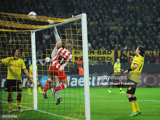 Roman Weidenfeller of Dortmund makes a save from Rafik Djebbour of Olympiacos during the UEFA Champions League group F match between Borussia...