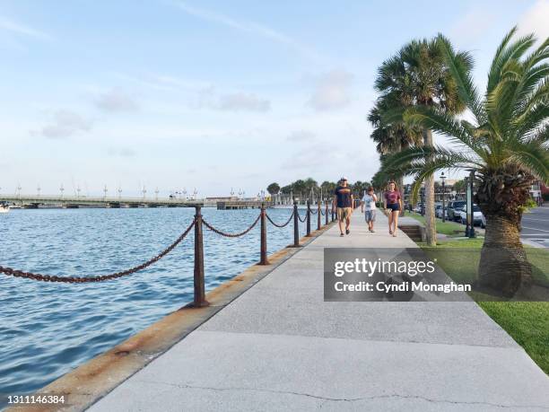 family walking along the seawall in st. augustine - st augustine florida stock pictures, royalty-free photos & images