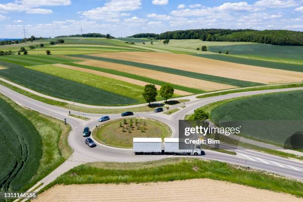 roundabout with cars and trucks, aerial view - traffic circle stock pictures, royalty-free photos & images