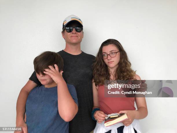 awkward family photo with annoyed siblings - embarrased dad stock pictures, royalty-free photos & images