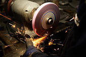 Grinding workmanship sparks in saw manufacturing workshop