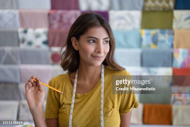 happy saleswoman working at a fabric shop - fabric shop stock pictures, royalty-free photos & images