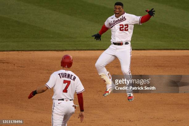 Juan Soto of the Washington Nationals celebrates his walk-off single with teammate Trea Turner against the Atlanta Braves during the ninth inning at...