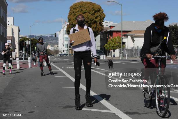 Khennedi Meeks, center, skates during a rally organized in solidarity against the recent spate of hate and violence directed against the AAPI...