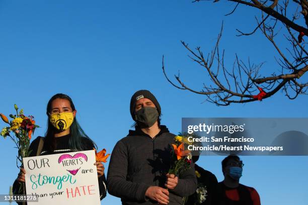 Cordelia Larsen and George McTernan, both of San Jose, stand beside one another as they gather with hundreds of other folks attending the "from the...