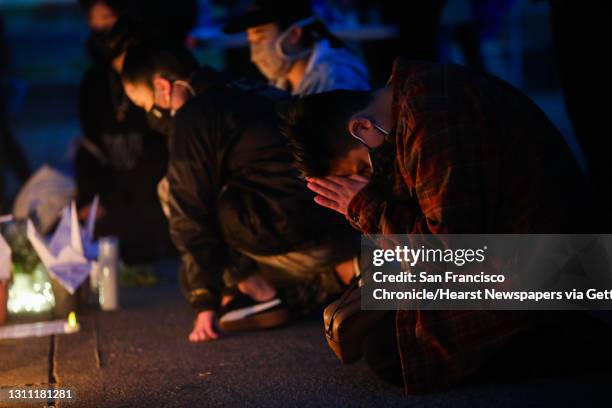 Kiara Konishi of Oakland prays in front of an altar as hundreds gather for the "from the Bay to Atlanta: on our minds, in our hearts" event at...