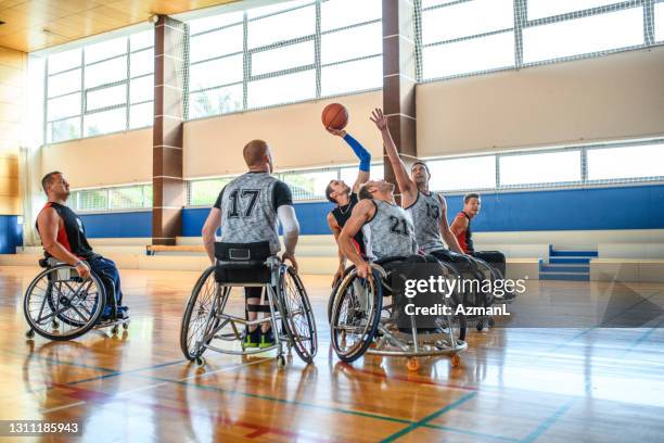 male wheelchair basketball players struggling for ball - adaptive athlete imagens e fotografias de stock