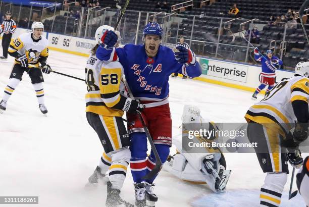 Chris Kreider of the New York Rangers celebrates a first period goal by Mika Zibanejad against Tristan Jarry of the Pittsburgh Penguins at Madison...