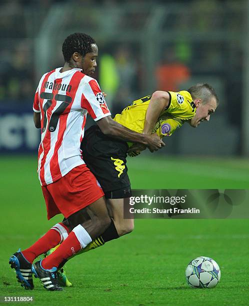 Kevin Grosskreutz of Dortmund is challenged by Jean Makoun of Olympiacos during the UEFA Champions League group F match between Borussia Dortmund and...