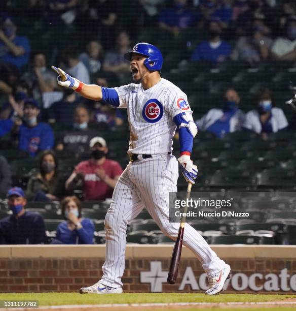 Willson Contreras of the Chicago Cubs reacts after getting hit by a pitch during the ninth inning of a game against the Milwaukee Brewers at Wrigley...