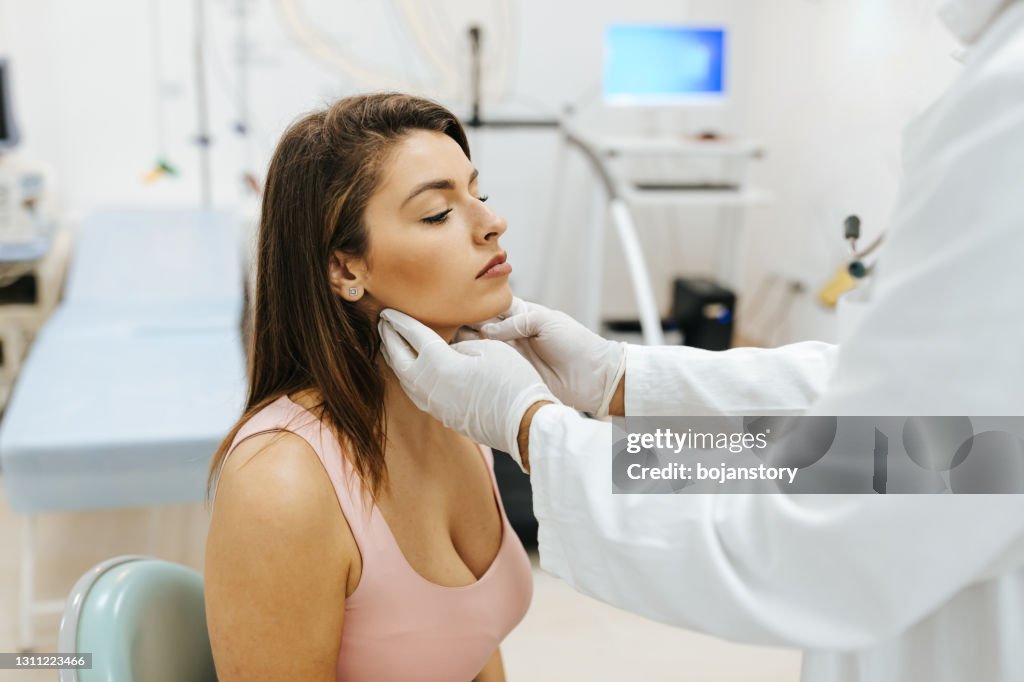 Checking thyroid glands at the doctor